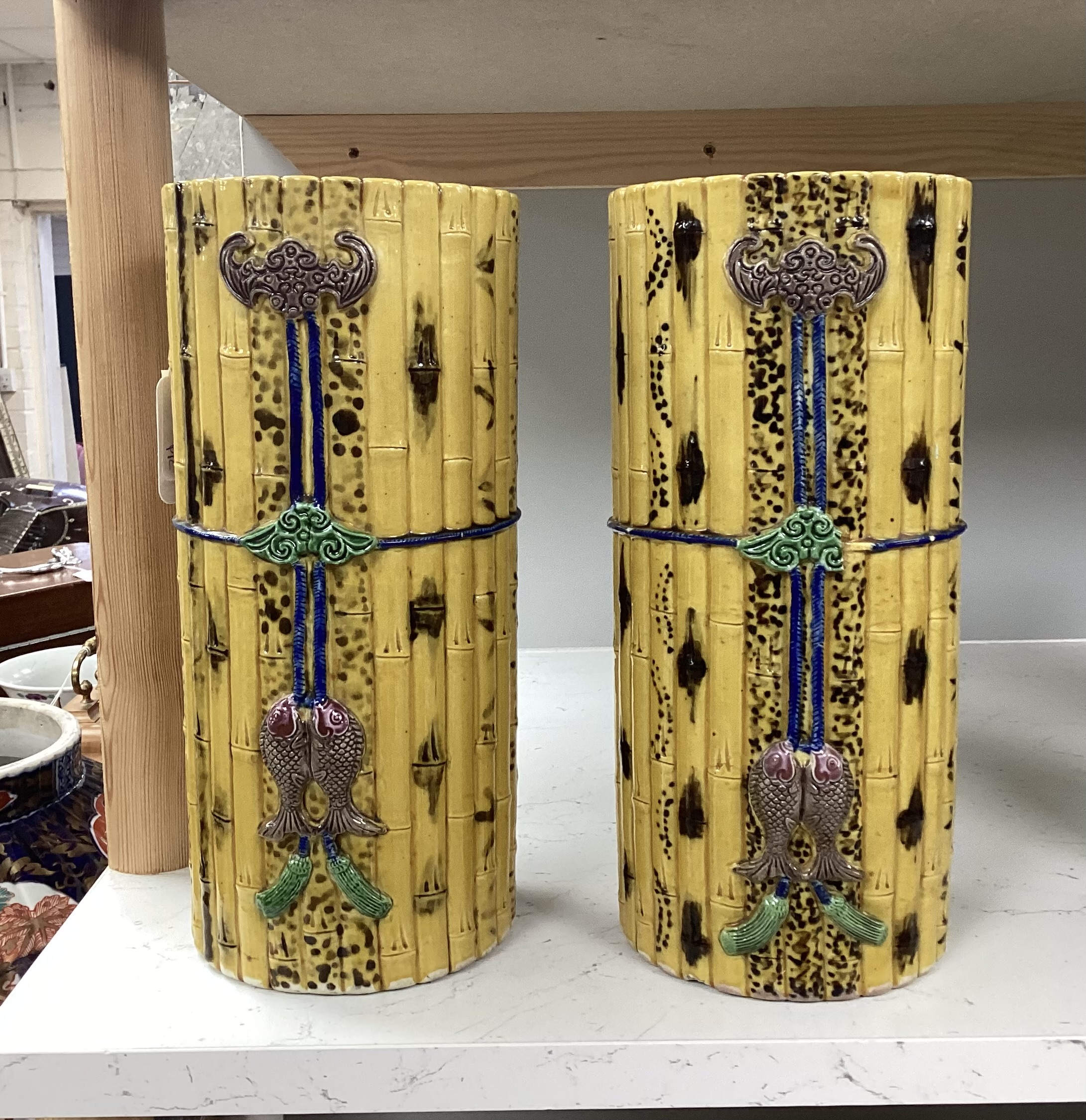 A pair of Chinese polychrome glazed faux bamboo vases, 19th century, 27cm high